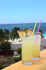 Tropical drink on the sea and sky background, shallow focus