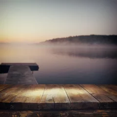  vintage wooden board table in front of abstract photo of misty and foggy lake at morning sunrise.   © tomertu
