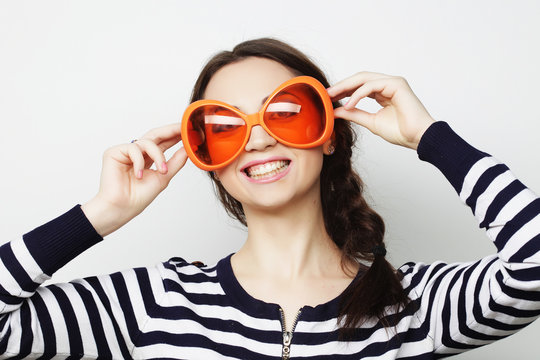young woman with big orange sunglasses 