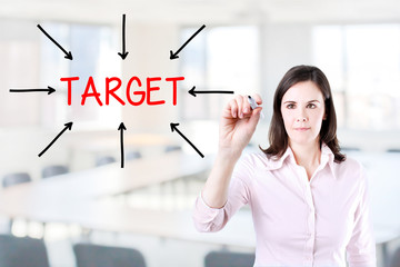 Young business woman access the target. Office background.