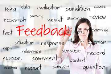 Young business woman writing feedback concept. Office background.
