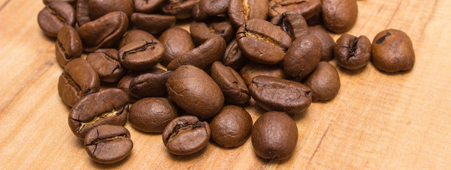 Heap of coffee beans on jute canvas on table