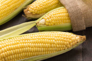 Fresh organic yellow sweet corn on wooden table