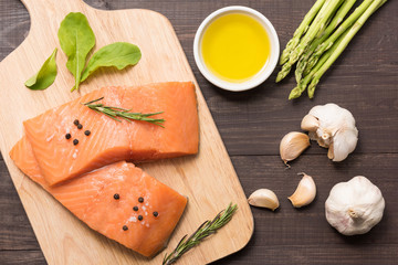 Fresh salmon fillet with spice on wooden background