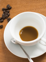 Empty white cup of hot coffee latte on wooden table