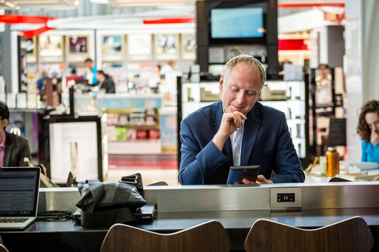 Businessman Using His Tablet At The Airport