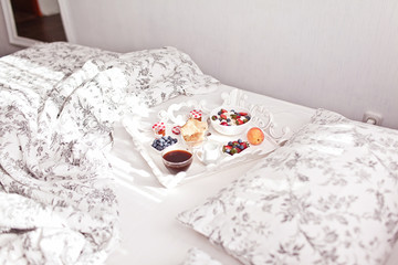 Fototapeta na wymiar Breakfast in Bed. Cottage Cheese, coffee, berries, cookies and jam. Sweet morning.