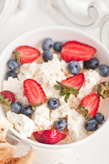 Breakfast in Bed. Cottage Cheese, berries, 	strawberries and cookies. Sweet morning.