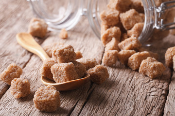 brown cane sugar on a wooden table macro. horizontal 

