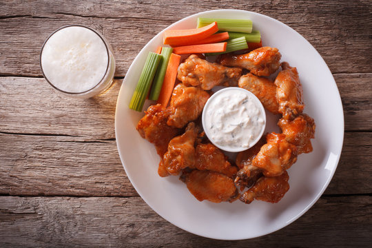 American fast food: buffalo wings and beer horizontal top view
