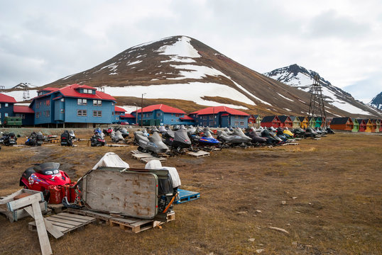 Snow mobiles parked infront of the houses in Longyearbyen