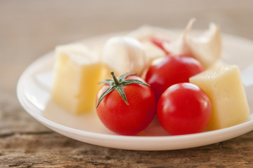 Italian cheese with tomato and garlic close up