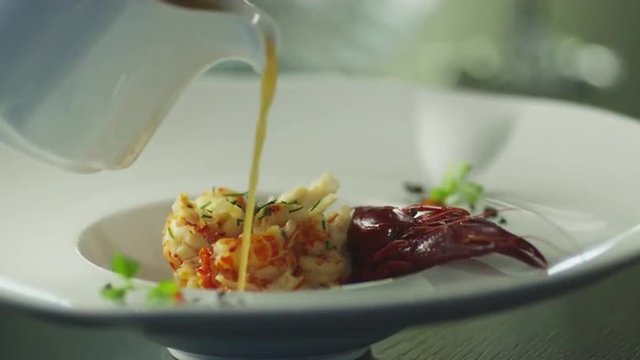 Chef is Garnish Dish with Lobster in Luxury Restaurant