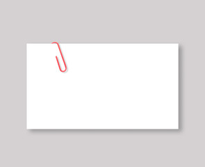 White blank space and red paper clip on grey background