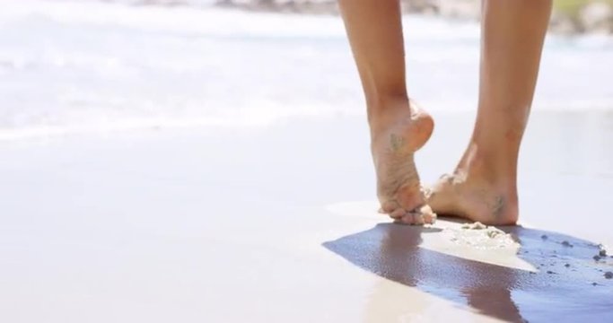 close up of woman feet walking on tropical beach island vacation