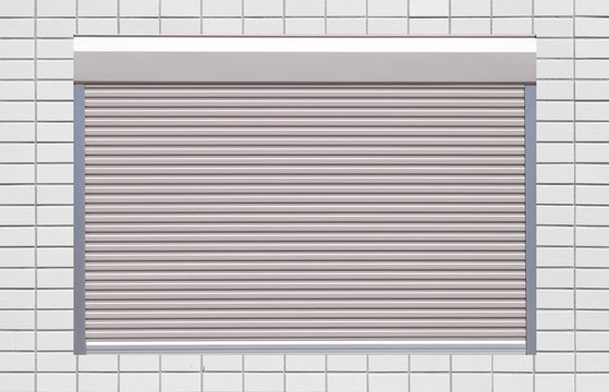 White metal roller window shutter and white brick wall .