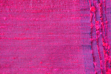 Red silk fabric folded background and texture