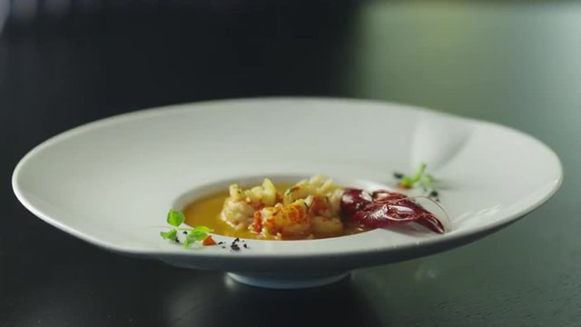 Chef is Garnish Dish with Lobster in Luxury Restaurant