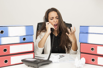 Businesswoman screaming into the phone