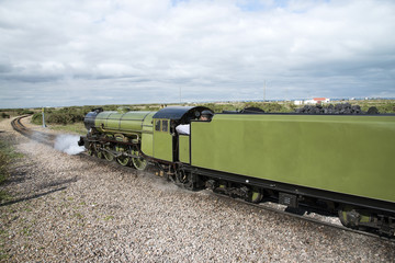 A vintage steam locomotive on a narrow guage track
