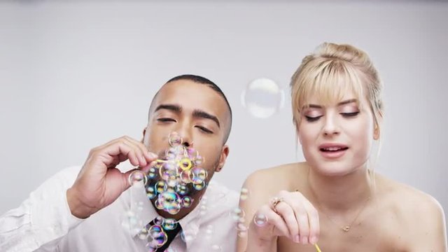 couple blowing bubbles slow motion wedding photo booth series