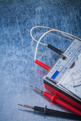 Electricians multimeter on scratched metallic surface construct
