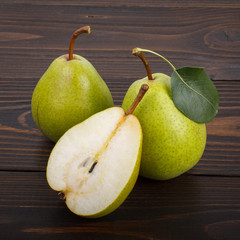Two and half  pears on a wooden background