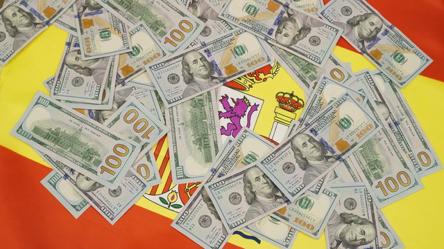 flag of Spain  and lots of hundred dollar bills 