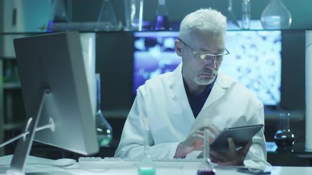Scientist is Using Tablet and Computer in Laboratory.

Shot on RED Cinema Camera in 4K (UHD).