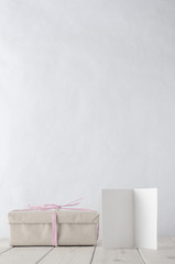 Wrapped Gift Box on Table with Icy Pink Raffia and Greeting Card