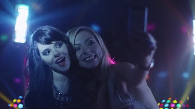 Two Girls are Doing Selfie in Nightclub