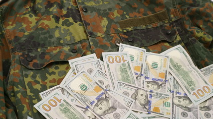 One hundred dollar bills on a military uniform