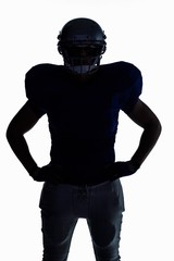 Silhouette American football player standing with hand on hip