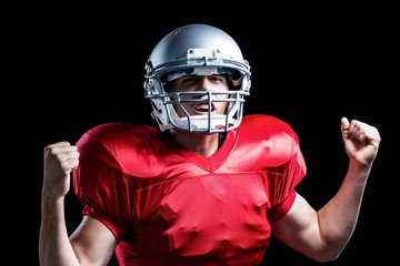 Portrait of American football player cheering with clenched fist