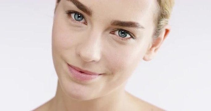 Closeup portrait of beautiful woman smiling bright blue eyes slow motion skincare concept - Red Epic Dragon
