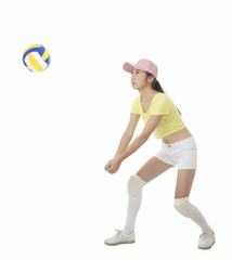 Asian teenage girl hitting a volleyball isolated on a white background