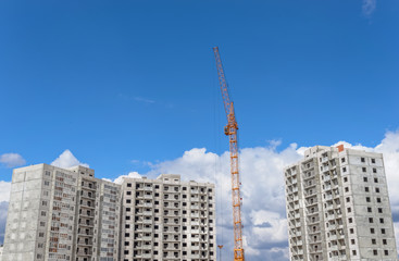 Fototapeta na wymiar Construction of building and tall cranes