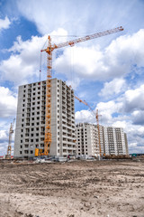 New high-rise houses and construction machinery