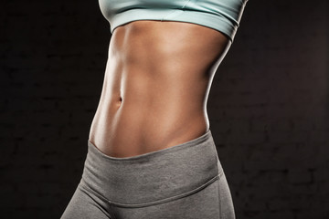 Fitness female woman with muscular body, do her workout, abs, abdominals