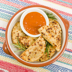 Pierogi - Baked dumplings filled with meat and served with a spicy sour cream based dip.
