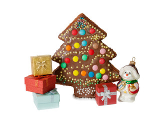 Homemade cake in a shape of a christmas tree, gift boxes isolated