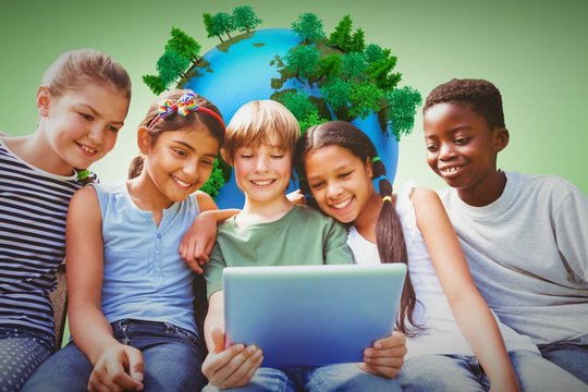 Composite image of happy children using digital tablet at park