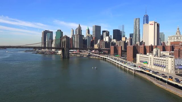 The Brooklyn Bridge, East River and FDR parkway on a clear sunny day in New York City.