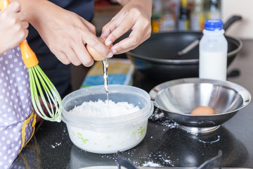 Little asian girl making pancake