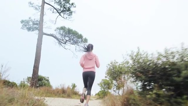 woman running trail steadicam shot