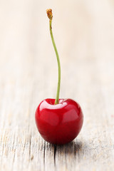 Sweet cherry on grey wooden background
