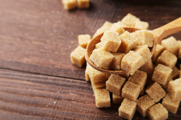 Brown sugar on brown wooden background