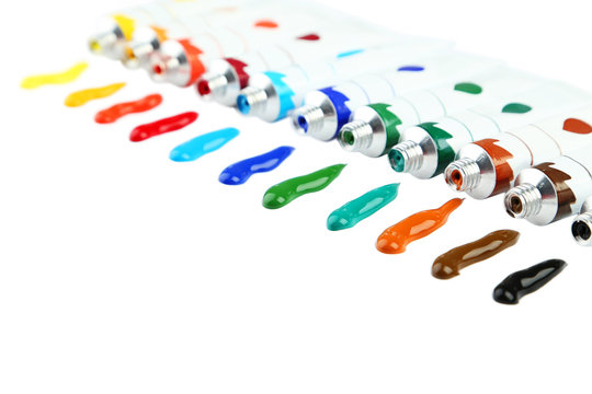 Colorful acrylic paints in tubes on white background