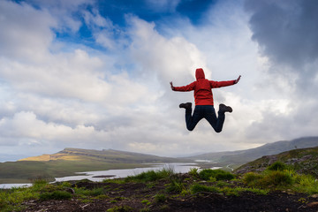 Man jumping on the top pf a mountain, Skye, Scotland