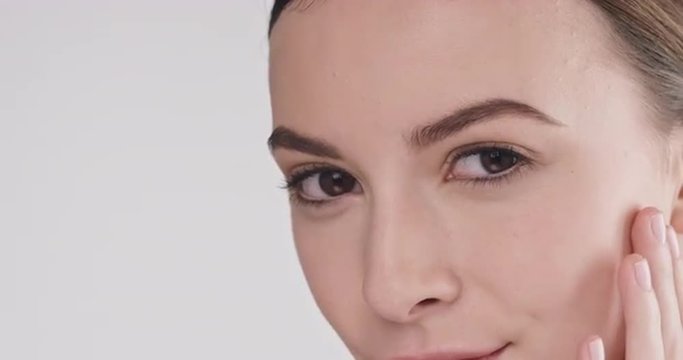 Beauty portrait of woman touching beautiful face slow motion skincare concept on a grey background slow motion Red Epic Dragon